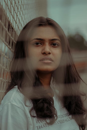 face of brunette, netting effect, thoughtful expression, young woman portrait, captivating portrait, brunette through net, netting portrait, thoughtful face, young woman face, netting photo, brunette portrait