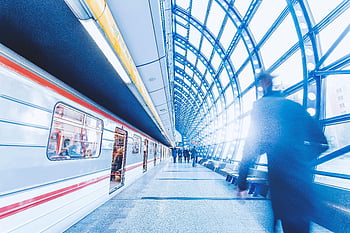 train station, commuters, modern subway, striking architecture, light play, blurred motion, urban transportation, public transit, station platform, architectural design, subway design