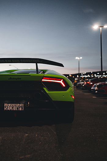 sports car, Lamborghini, parked, concrete pavement, parking lot, rear view, dusk, parking lot lights, green car, sports car photo, car photography