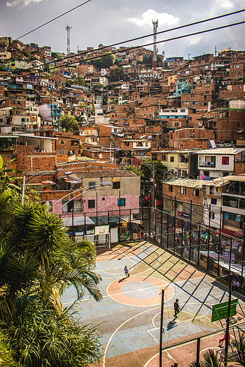 basketball court, city favela, Medellín Colombia, aerial view, colorful basketball court, dense favelas, urban sports, community court, outdoor basketball, hillside favela, vibrant court