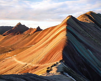 Rainbow Mountain, Peru, vibrant colors, natural mineral deposits, brown rocky mountain, cloudy sky, scenic landscape, colorful mountain, geological wonder, travel destination, outdoor adventure