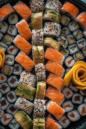 sushi platter, fresh salmon, avocado, rolled sushi, beautifully arranged, sesame seeds, sushi servings, orange roe, yellow rose, black sesame, white sesame