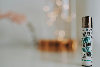 fehér címkés öngyújtó, fehér felület, közelkép, művészi szöveg, álmodozó bokeh, divatos öngyújtó, bokeh hatása, fehér háttér, könnyebb kialakítás, modern öngyújtó, bokeh világítás