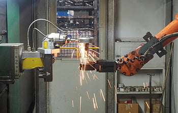 robotic arm, industrial machine, welding, steel, bright sparks, industrial setting, automation, manufacturing, metalworking, robotic welding, sparks