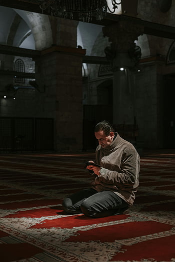 man, mosque, sitting, floor, cell phone, historic, beautiful architecture, contemplation, interior, prayer, rug