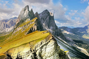 Gray Rock Formation, jagged mountain peaks, lush valleys, vibrant blue sky, natural landscape, mountain scenery, outdoor beauty, alpine view, rocky terrain, scenic vista, high altitude