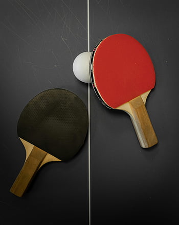 table tennis, ping pong paddles, white ball, top view, table tennis setup, sports equipment, recreational activity, indoor game, competitive sport, racket sports, ping pong ball
