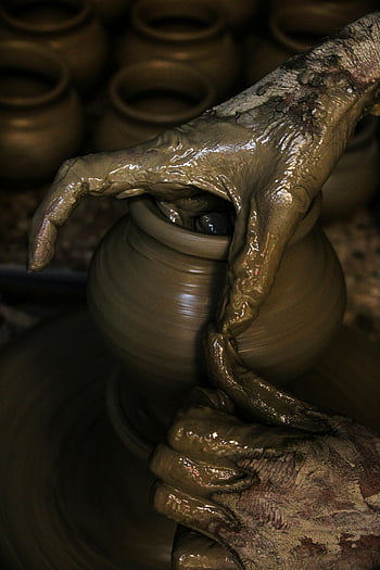 clay pot, pottery wheel, hands shaping clay, traditional craftsmanship, close-up photography, ceramic art, potter's wheel, handmade pottery, clay molding, pottery making, artisan skills