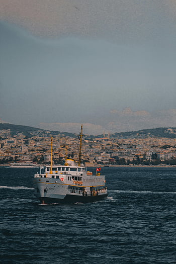 ferry boat, deep blue sea, vibrant ferry, bustling cityscape, sea navigation, city background, maritime transport, ocean vessel, urban waterfront, water transport, sea travel