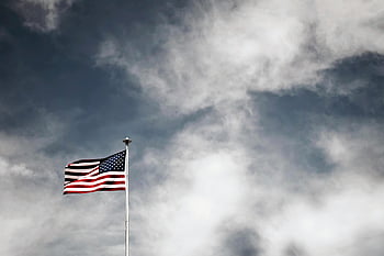 American flag, USA flag, flag pole, cloudy sky, vibrant flag, waving flag, freedom symbol, patriotism, striking sky, USA symbol, American patriotism