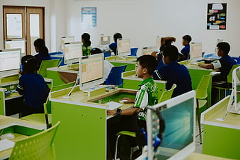 students using computers, children educational activities, modern computer lab, kids learning technology, classroom technology use, educational technology, computer lab setting, students on computers, educational computing, children on computers, modern classroom technology