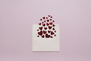 hearts, envelope, red glitter hearts, pastel pink background, open envelope, cascading hearts, romantic image, valentine's day, love symbol, festive decoration, heart shapes