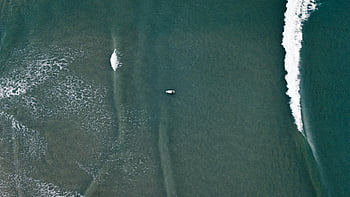aerial photography, body of water, drone shot, lone surfer, ocean waves, beach sports, themes, surfboard, coastal scene, top view, wave patterns