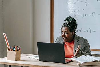 Black teacher, distance learning, laptop, online math, whiteboard, female teacher, enthusiastic teaching, virtual classroom, online education, remote teaching, e-learning