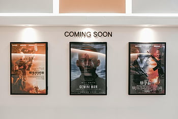 movie posters, cinema hallway, coming soon, framed posters, assorted movies, upcoming movies, gemini man, will smith, movie promotion, cinema decor, movie advertising