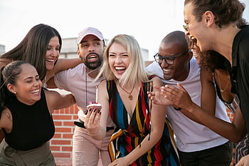birthday celebration, diverse friends, cheerful woman, rooftop party, cupcake, laughter, joyful friends, vibrant moment, terrace gathering, young people, celebration event