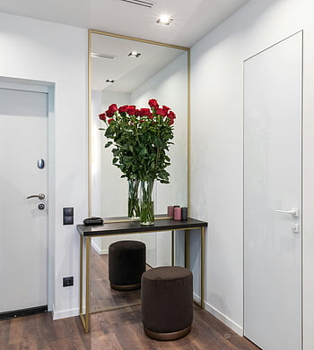 stylish interior, minimalist console, red roses, large mirror, modern decor, flower vase, pouf, console table, interior design, contemporary style, home decor