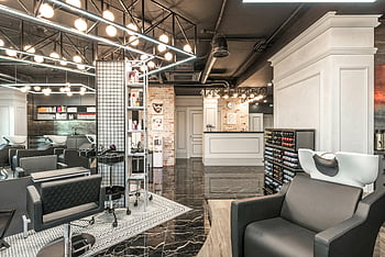 backwash chair, contemporary beauty studio, salon interior, sleek furniture, elegant lighting, professional wellness services, spacious salon, modern salon design, beauty salon decor, salon seating, salon lighting