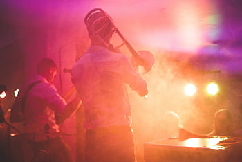 live music performance, trombone player, stage, nightclub setting, vibrant, musicians, performance, nightclub, stage lighting, musical instruments, entertainment