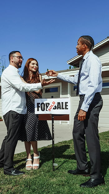 real estate, house keys, couple, realtor, newly sold house, for sale sign, home buying, property transaction, man in dress shirt, key handover, perfect real estate imagery