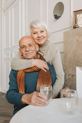 elderly couple, warm moment, loving couple, drinking together, indoor photo, senior couple, happy elderly, cozy setting, affectionate couple, mature love, elderly love