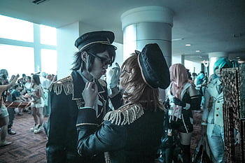 cosplay, anime festival, indoor event, diverse costumes, community spirit, vibrant atmosphere, cosplayers, two people, about to kiss, anime convention, uniform costumes