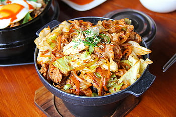 Korean stir-fried noodles, vegetables, meat, traditional stone bowl, cooked food, black bucket, savory dish, Asian cuisine, noodle dish, Korean food, stir-fry