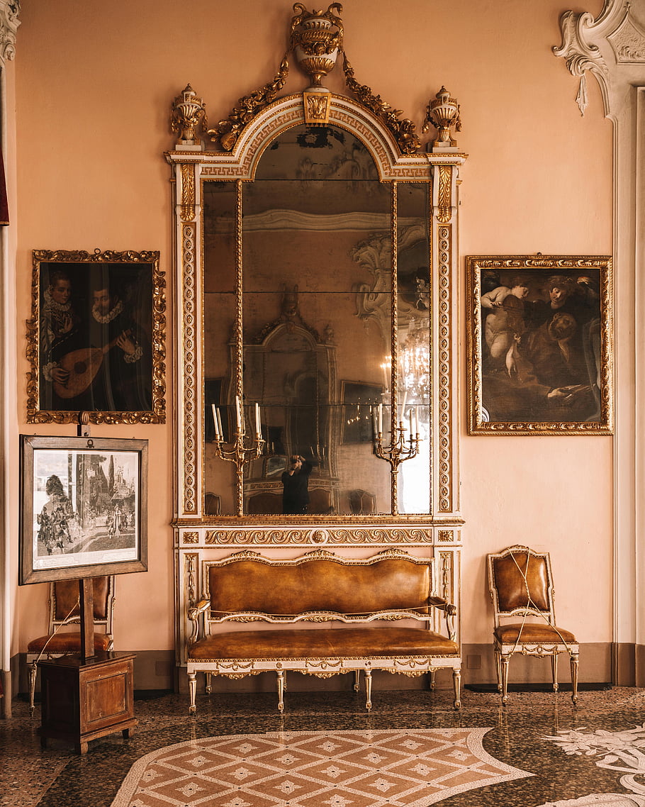 Italian palace, ornate mirror, luxurious interior, antique furniture, art, gold frame, vintage decor, elegant room, historical setting, ornamental design, chandelier reflection