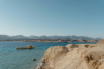 submarine at sea, coastal landscape, vibrant yellow submarine, clear blue waters, coastal scenery, submarine in water, yellow submarine, blue ocean, coastal view, submarine adventure, sea view