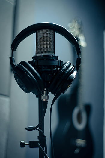 headset, microphone, recording studio, dimly lit, headphones, stand, close-up, audio equipment, music production, sound recording, studio setup