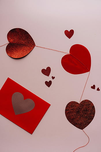 red hearts, red envelope, Valentine's decor, flat lay, heart shapes, glitter hearts, romantic decor, Valentine's Day, love symbols, heart decorations, festive arrangement