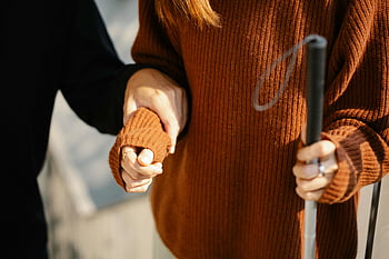 man holding woman's arm, close-up hands, walking cane, support, visual aid, couple, assistance, help, companionship, disability, aid