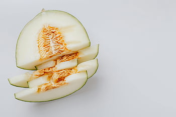 sliced melon, honeydew melon, fresh melon, melon seeds, white background, fruit slices, melon texture, fresh fruit, melon pieces, summer fruit, melon slices