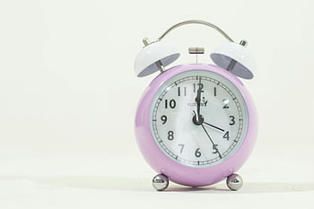 lilac alarm clock, minimalist design, white background, time themes, punctuality, white bells, clock face, analog clock, simple design, desk clock, pastel colors
