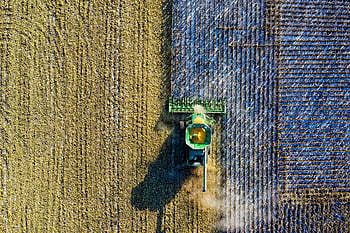 aerial shot, green milling tractor, combine harvester, cornfield, harvest season, rural Minnesota, drone shot, agricultural machinery, farming equipment, field work, aerial photography