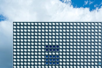 modern building, circular patterns, abstract view, Utrecht, building facade, cloudy sky, dots, sunlight, architectural design, contemporary architecture, urban landscape
