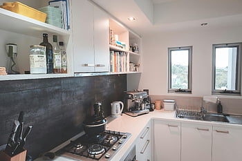 kitchen interior, white cupboards, modern appliances, contemporary kitchen, sleek design, natural lighting, kitchen appliances, kitchen sink, kitchen shelves, kitchen counter, kitchen windows