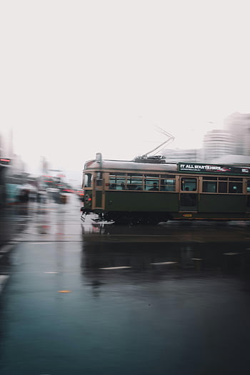 long-exposure, tram, rainy Melbourne, historic tram, vibrant shot, dynamic urban transport, cityscape, urban scene, public transportation, wet streets, reflections
