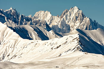 snow-covered mountain, blue sky, mountain range, clear sky, breathtaking view, winter landscape, alpine scenery, snow-capped peaks, mountain peaks, natural beauty, outdoor scenery