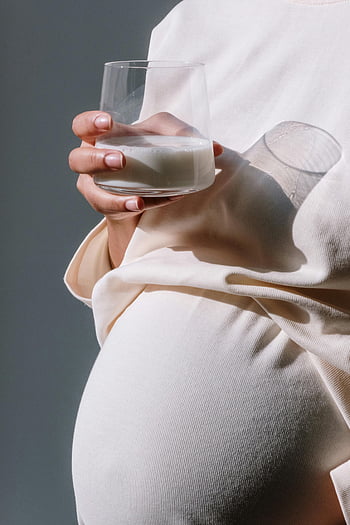 gestante, Abito di maternità beige, bicchiere di latte, Nutrire cure, avvicinamento, gravidanza, moda premaman, pancia incinta, gravidanza sana, nutrizione in gravidanza