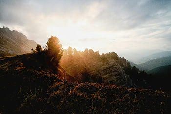 Mountain Ranges, Golden Hour, sunrise, rugged landscape, trees, sun rays, breaking clouds, mountainous terrain, natural scenery, outdoor beauty, scenic view