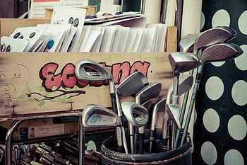 vintage golf clubs, flea market, retro decor, golf bag, black golf bag, golf clubs, flea market setting, retro golf clubs, vintage clubs, golf equipment, flea market display