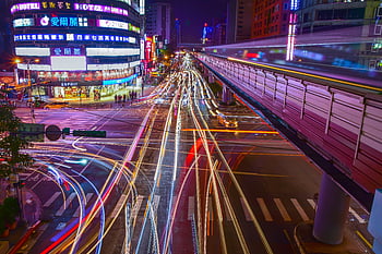 light trails, city street, urban motion, neon lights, night photography, dynamic intersection, colorful lights, city nightlife, urban energy, long exposure, cityscape photography
