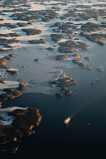 aerial view, large number of islets, ship navigation, Sweden archipelago, sunset scene, waterway travel, coastal landscape, natural scenery, winter landscape, frozen water, island cluster