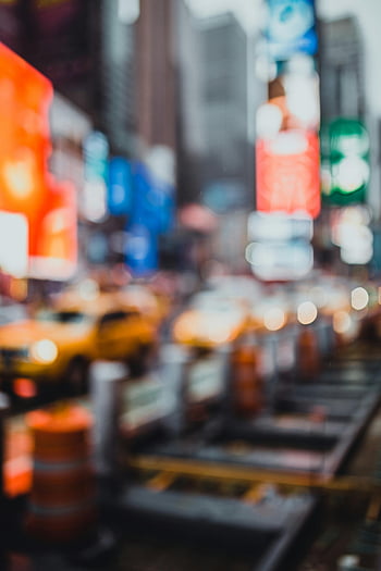 city in blur, defocused urban scene, illuminated signs, bustling traffic, iconic city street, night scene, city life, urban nightlife, bokeh effect, cityscape, street lights