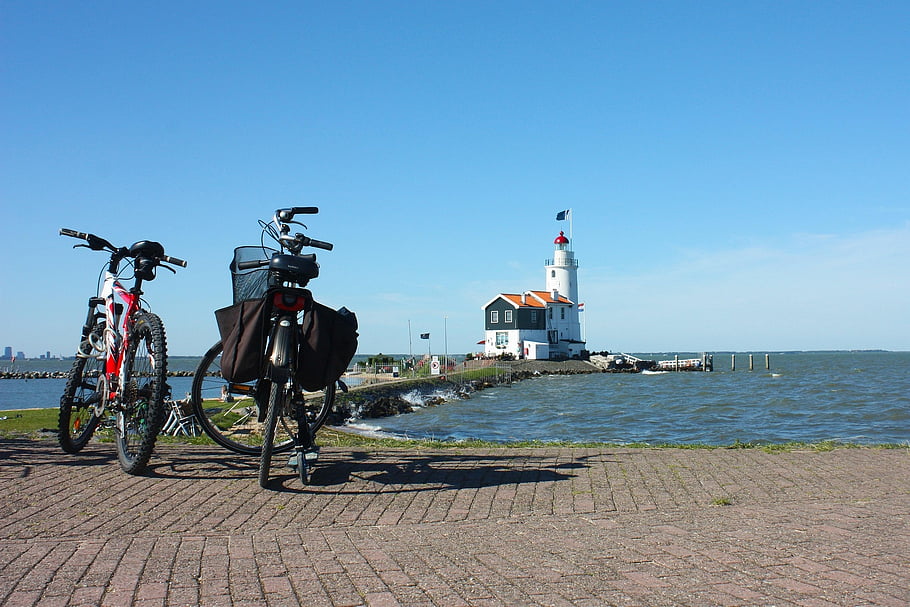 lighthouse, bicycles, sea, holland, sky, landscape, horizon, water