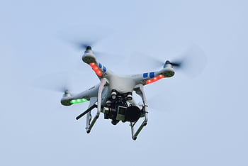 DJI Phantom, quadcopter drone, flying drone, camera drone, clear blue sky, close-up drone, aerial photography, remote control drone, unmanned aerial vehicle, drone technology, white black drone