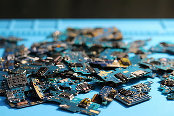 disassembled circuit boards, close-up electronics, tech themes, blue surface, pile of circuit boards, electronic components, disassembled electronics, tech photography, circuit board pile, electronic parts, tech background