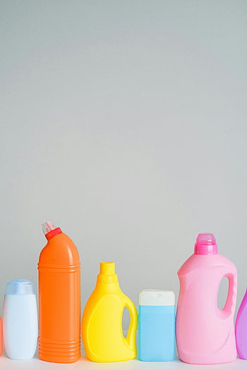 cleaning products, white background, plastic bottles, vibrant assortment, neatly arranged, shelf, copyspace, laundry detergent, household cleaners, colorful bottles, cleaning supplies