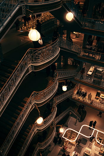 La Samaritaine, Parisian department store, ornate staircases, warm lighting, stylish interior, Paris, department store, interior design, luxury shopping, retail space, architectural details